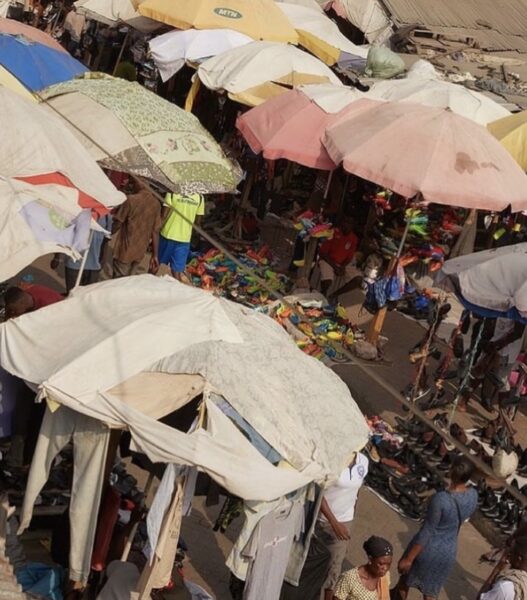 an overhead view of patchwork umbrellas covering a street market