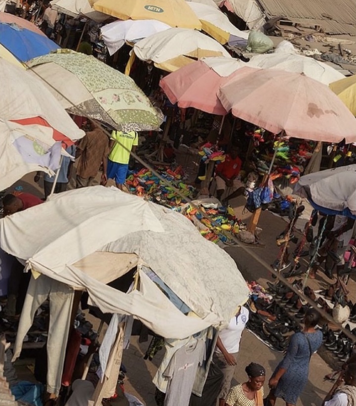 an overhead view of patchwork umbrellas covering a street market