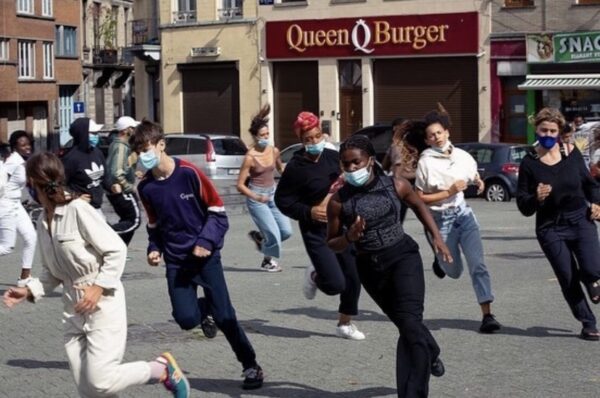 a group of people running in an outdoor plaza