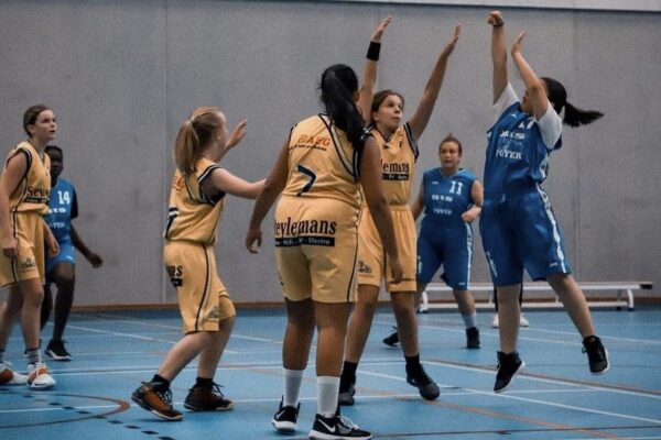 a group of girls playing basketball