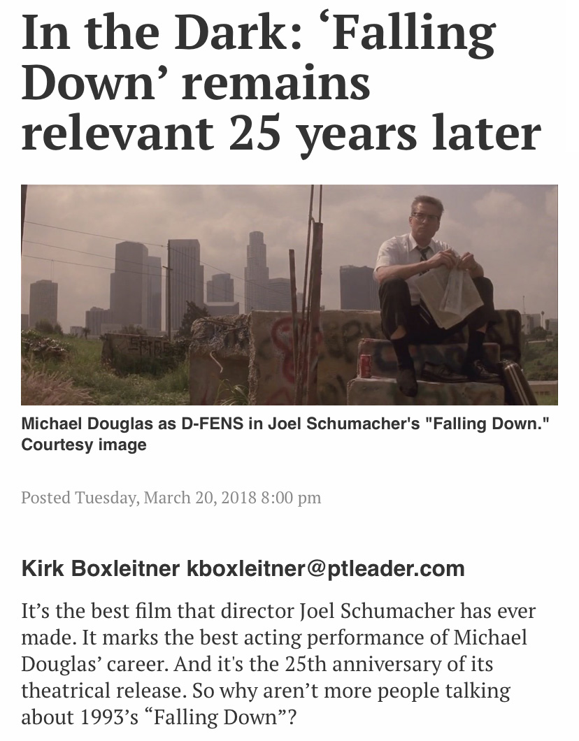 Michael Douglas sits in front a hazy Los Angeles city scape below a headline that reads "In the Dark: ‘Falling Down’ remains relevant 25 years later"