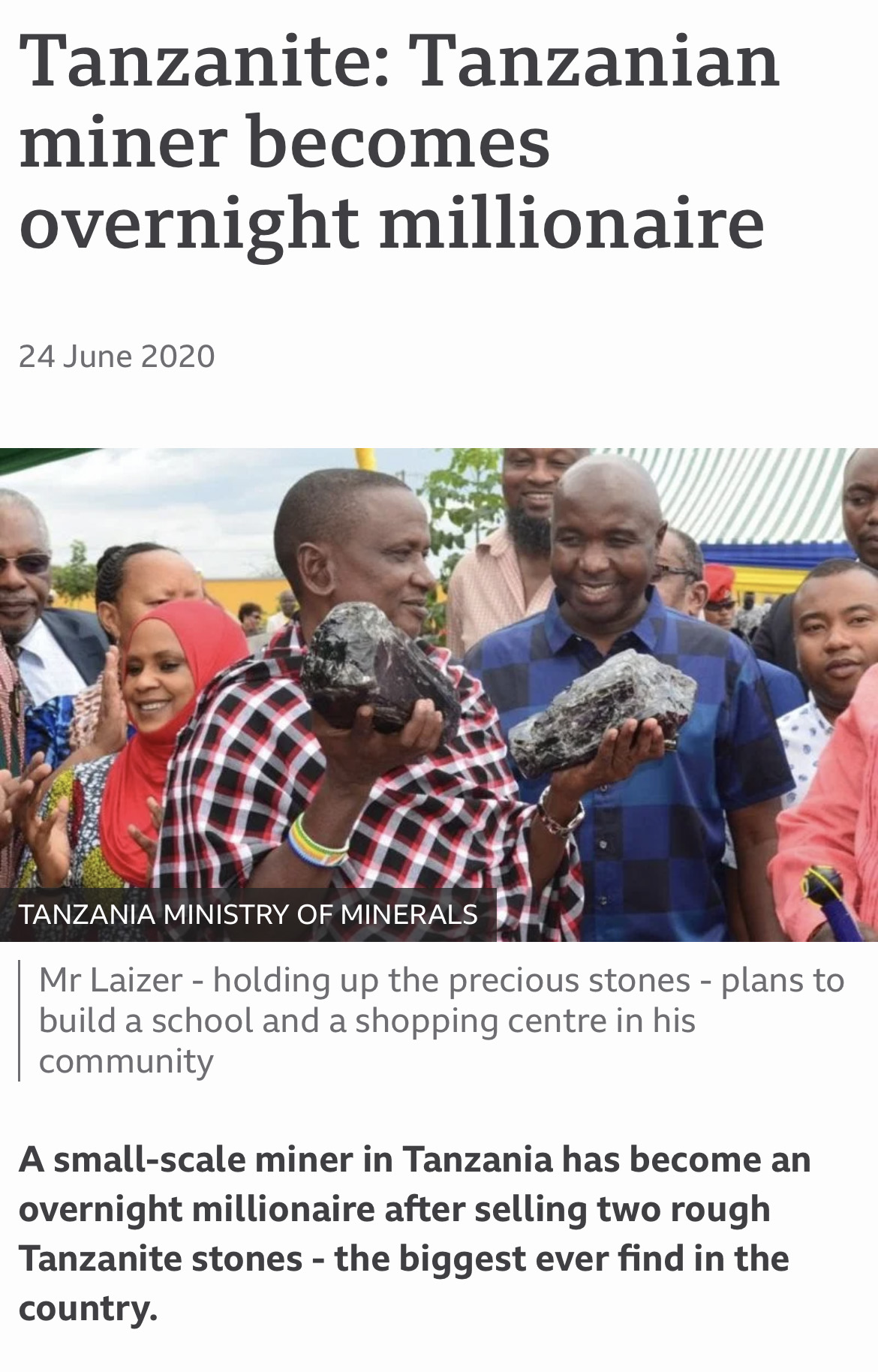 A man in front of a crowd holding two pieces of rock above a headline that reads "Tanzanite: Tanzanian miner becomes overnight millionaire"