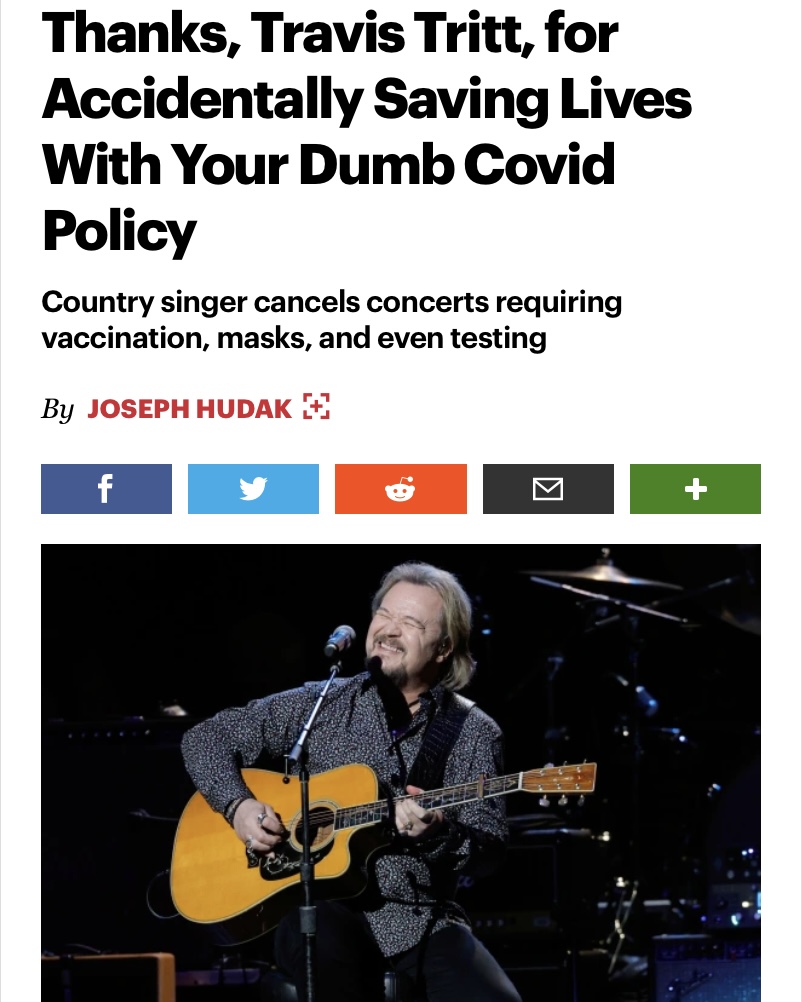 Travis Tritt grinning and playing guitar on a dark stage below a headline that reads "Thanks, Travis Tritt, for Accidentally Saving Lives with Your Dumb Covid Policy"