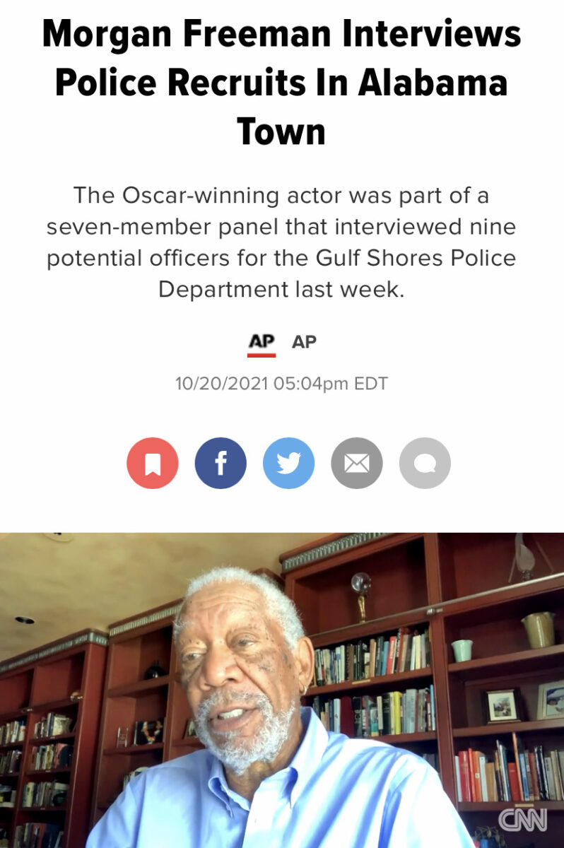 Morgan Freeman on a zoom call below a headline that reads "Morgan Freeman Interviews Police Recruits in Alabama Town"