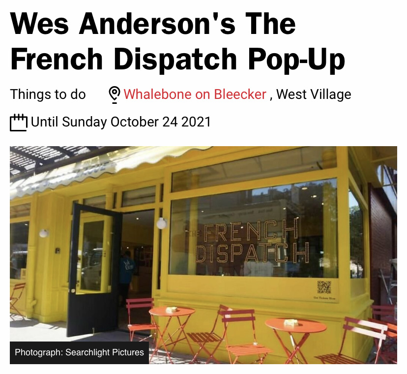A yellow painted cafe facade with French Dispatch painted in the window beneath a headline that reads "Wes Anderson’s The French Dispatch Pop-Up"