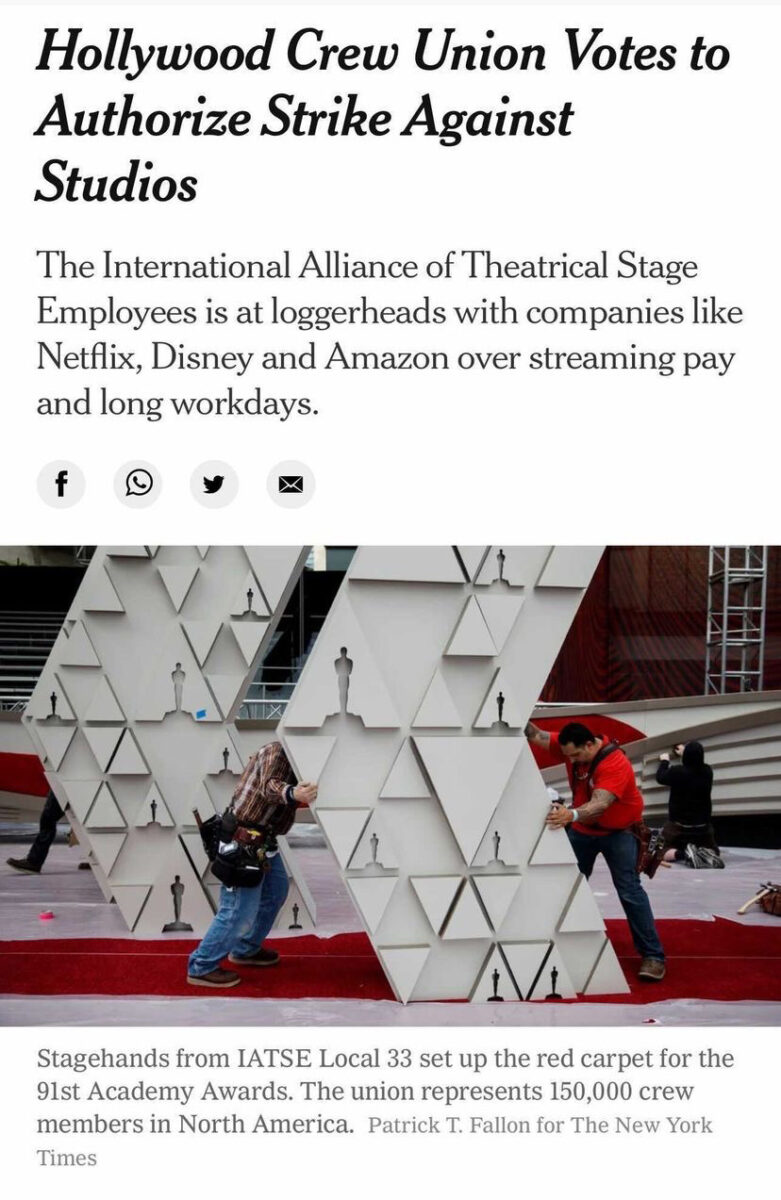 Workers building a set for the Oscar's below a headline that reads "Hollywood Crew Union Votes to Authorise Strike Against Studios"