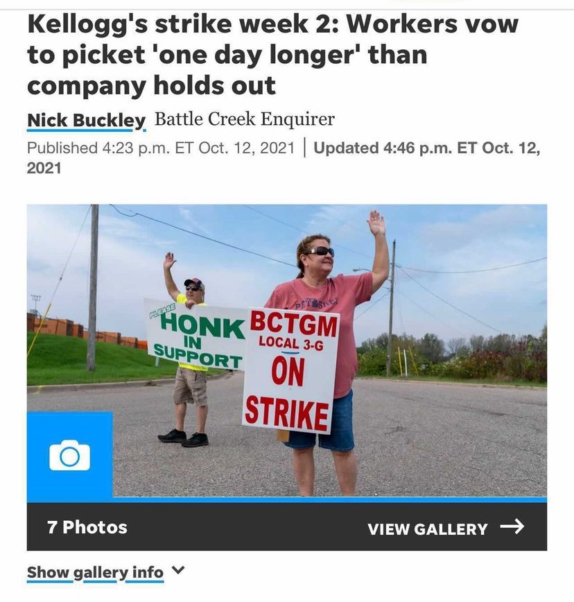 People standing outside with protest signs below a headline that reads "Kellogg’s strike week 2: Workers vow to picket ‘one day longer’ than company holds out"