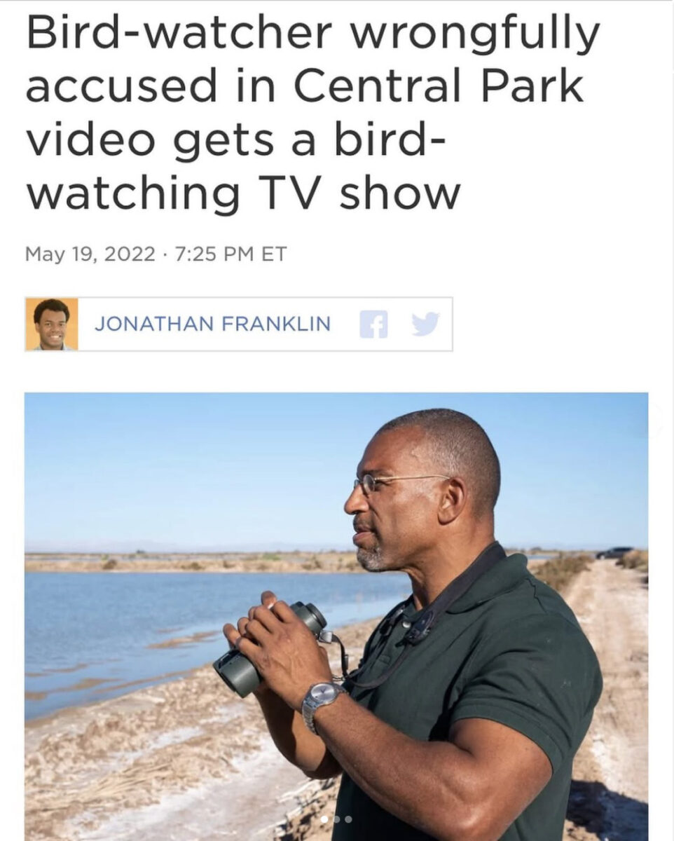 man wearing glasses holding binoculars in front of a body of water beneath a headline that reads "Bird-watcher wrongfully accused in Central Park video gets a bird-watching TV show"
