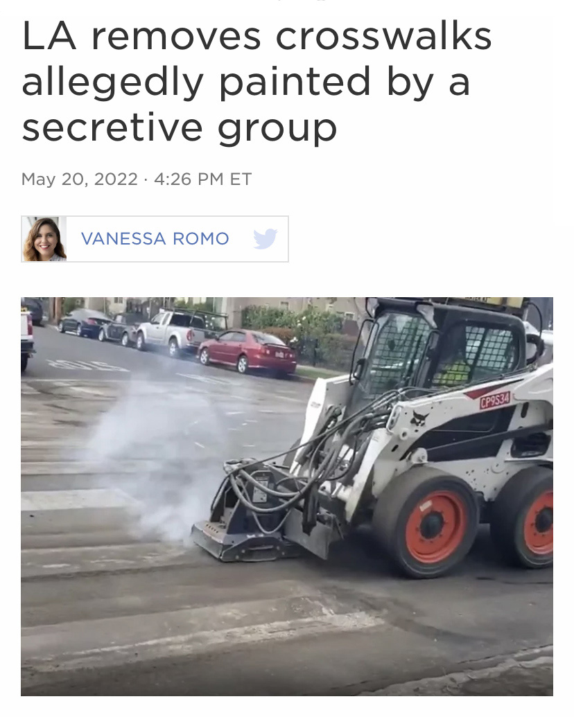 an industrial vehicle removing a painted crosswalk beneath a headline that reads "LA removes crosswalks allegedly painted by a secretive group"