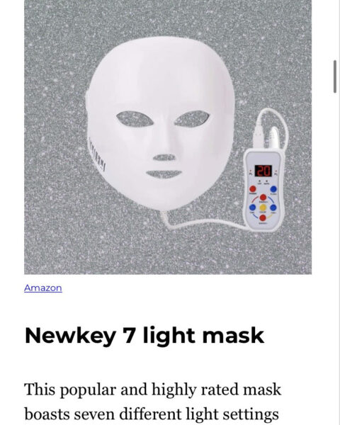 a white facemask attached to a remote control above text that reads "Newkey 7 light mask"