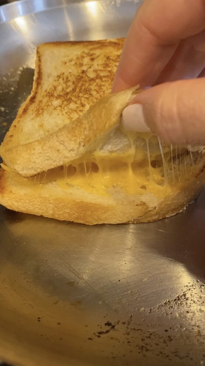a grilled cheese being opened up