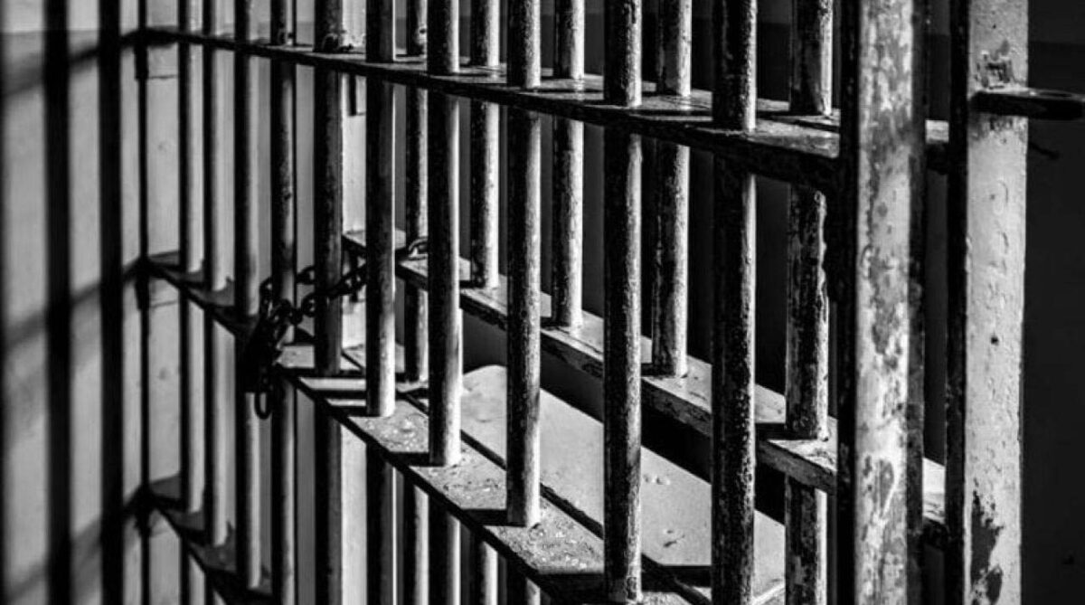 close up of prison bars in black and white