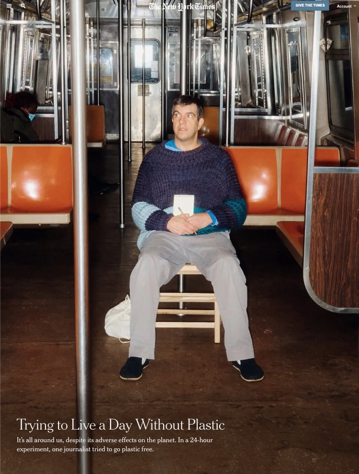 man sits alone in an NYC subway car looking perturbed above a headline that reads "Trying to Live a Day Without Plastic"