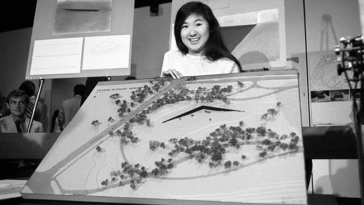 artist Maya Lin holding up a model of her Vietnam Veterans Memorial